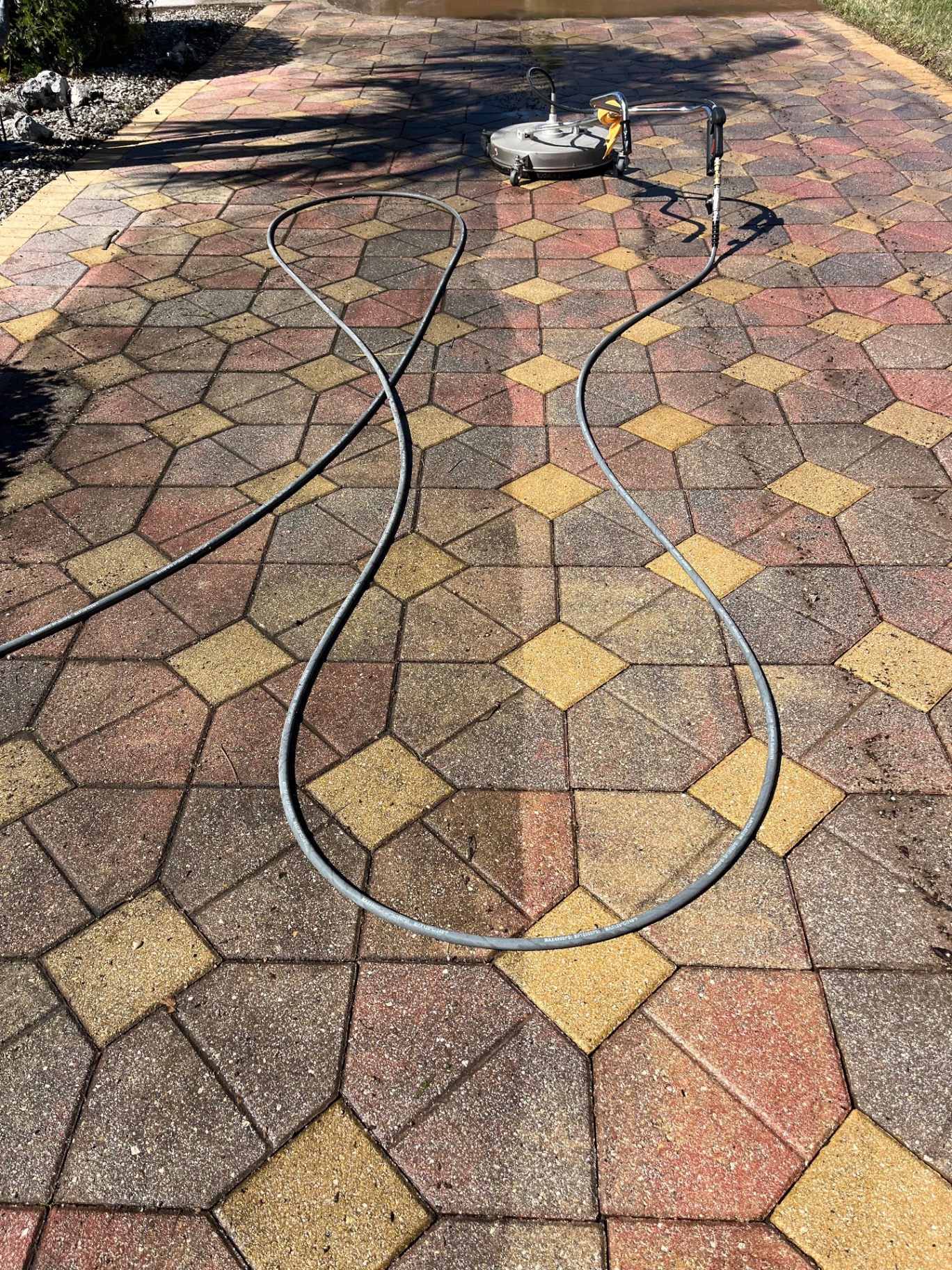 Brick paver driveway with surface cleaner restoring original color